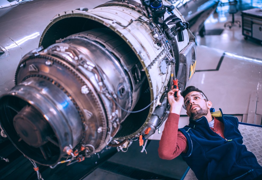 mechanic working on jet engine large