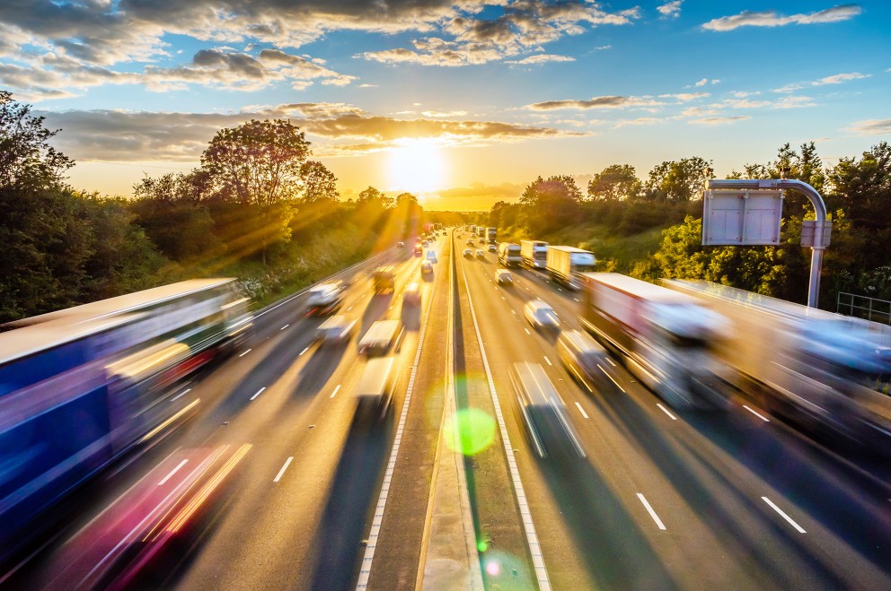 blurred image of vehicles traveling on highway large