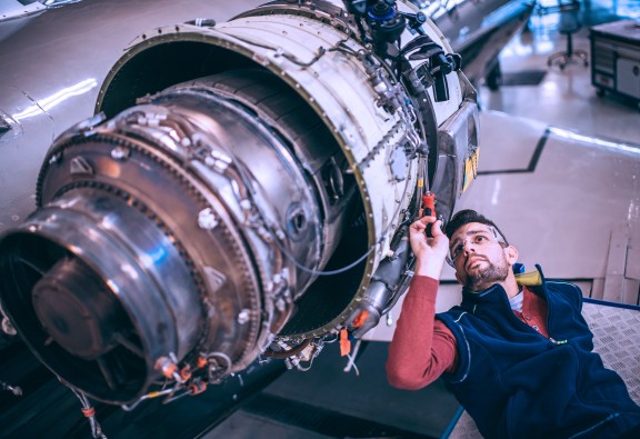 mechanic working on jet engine small