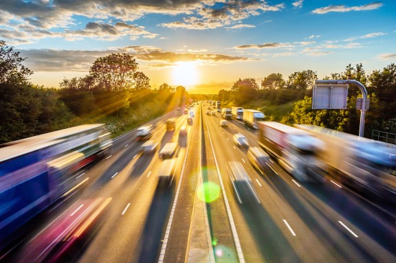 blurred image of vehicles traveling on highway small